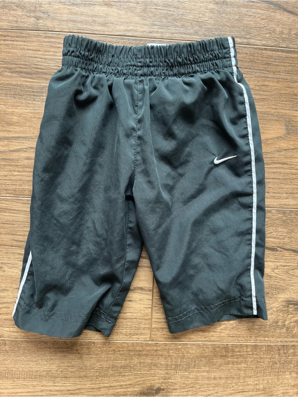 Nike Kids black Athletic pants with White Side Stripes windbreaker material